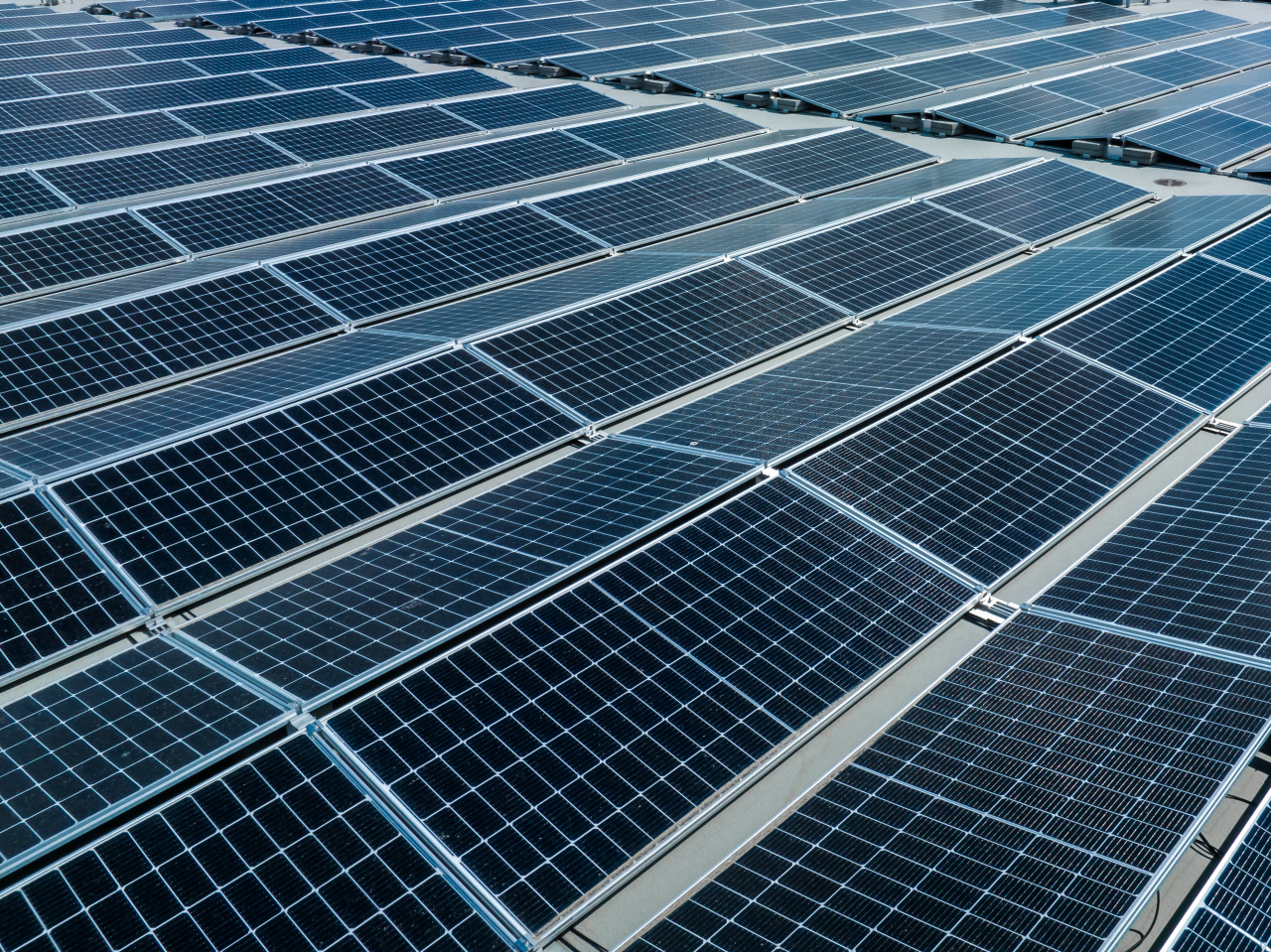 Section sections of solar panels on the background of a blue sky with white clouds
